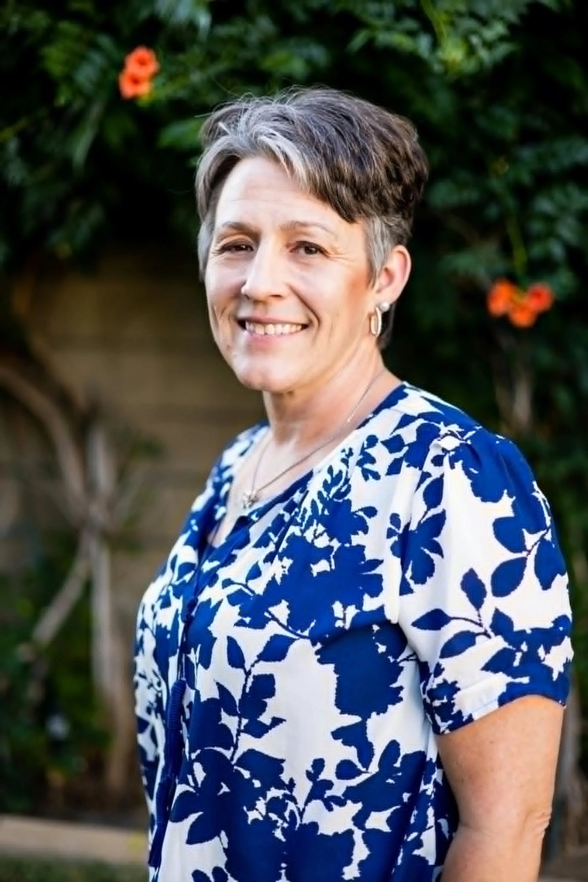 Meg Harkins, co-founder of Bee Courageous at Garden Grub, smiling in a garden